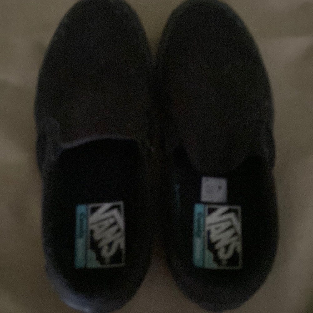Black Vans slip on sneakers